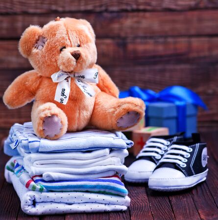 Clear baby clothes on the wooden tableの写真素材