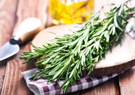 green rosemary with knife on a tableの写真素材