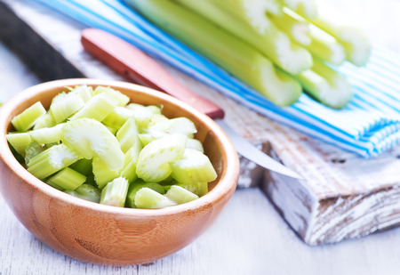 celery in bamboo bowl and on a tableの写真素材