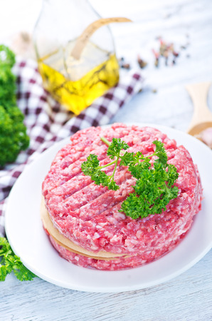 raw burgers on board with salt and spiceの写真素材