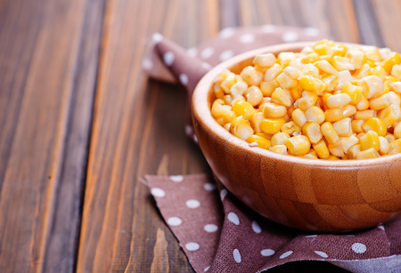 yellow corn in bamboo bowls and on a tableの写真素材