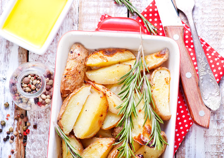 baked potato in bowl and on a tableの写真素材
