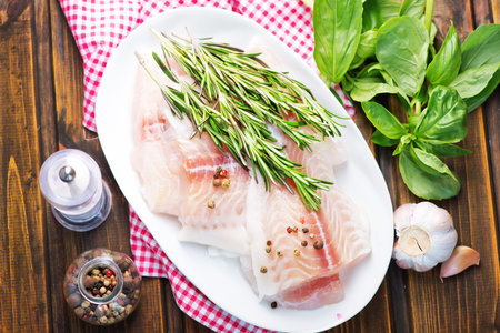 raw fish with spice and pepper on a table