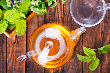 fresh herb and herbal tea on a tableの写真素材