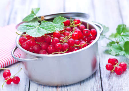 red currant in bowl and on a tableの写真素材