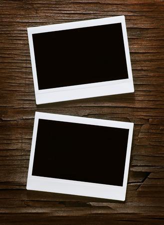 Blank instant photo frames on old wooden backgroundの写真素材