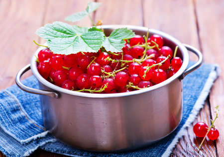 red currant in bowl and on a tableの写真素材