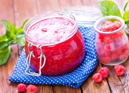 fresh raspberry and jam in glass bank