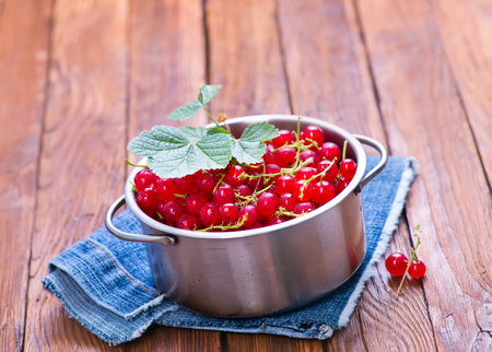 red currant in bowl and on a table