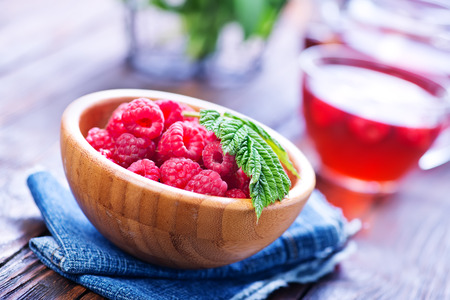 raspberry tea and fresh berries on a tableの写真素材