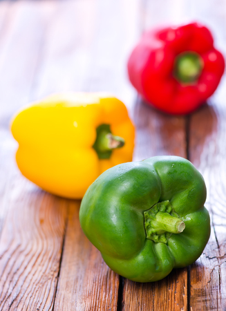 color peppers on the wooden table, red and yellow peppersの写真素材