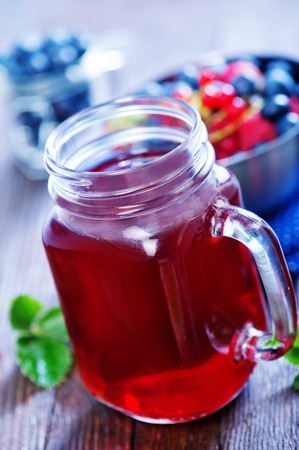 compot from berries in glass and on a tableの写真素材