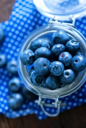 fresh blueberry in glass and on a tableの写真素材