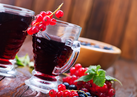 juice from berries in glasses and on a tableの写真素材