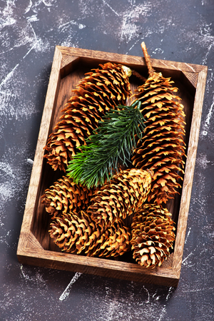 christmas decoration, cones and branch on a tableの写真素材
