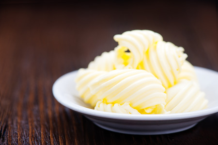 butter on plate and on a tableの写真素材