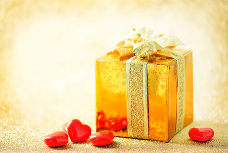 box for present and hearts on a tableの写真素材