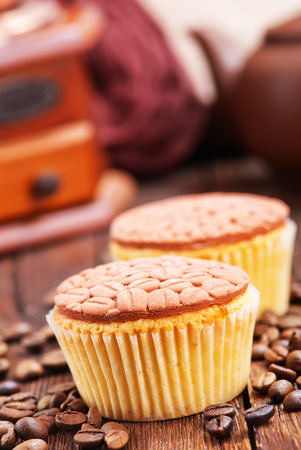 coffee muffins and coffee beans on a tableの写真素材