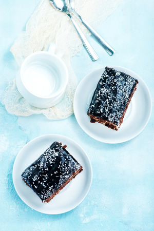 chocolate cake on plate and on a tableの写真素材