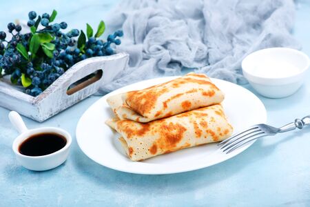 pancakes on plate and on a tableの写真素材