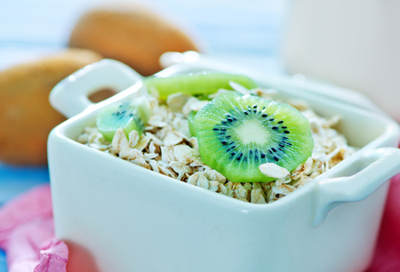 oat flakes with kiwi in the bowlの写真素材