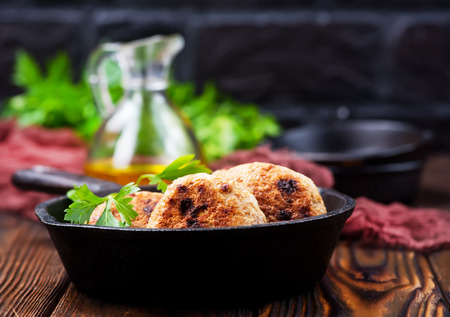 fried cutlets in pan and on a tableの写真素材