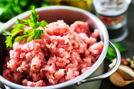 minced meat in bowl and on a tyableの写真素材
