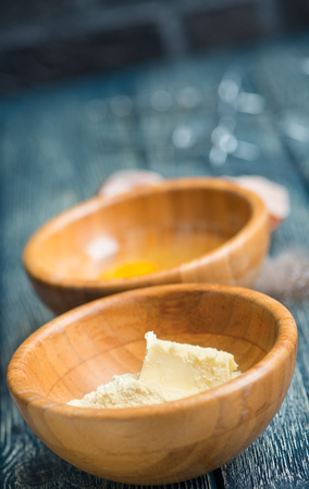 ingredients for baking, flour and eggs in bowlsの写真素材