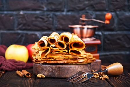pancakes on wooden board and on a tableの写真素材