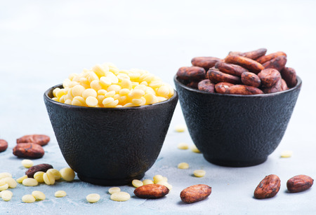 cocoa butter and cocoa beans in bowlの写真素材