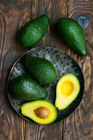 fresh green avocado on the wooden tableの写真素材