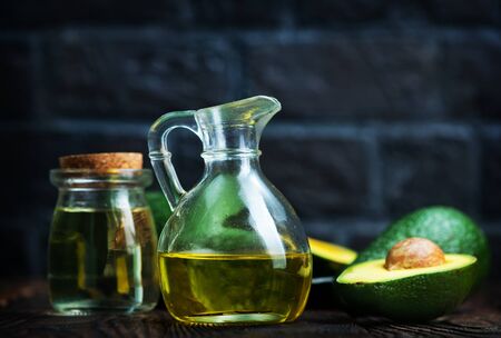 fresh avocado and oil in glass jugの写真素材