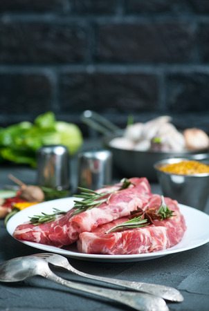 raw meat with spice on plate and on a tableの写真素材