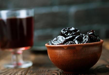 dry plums and drink in the glassの写真素材