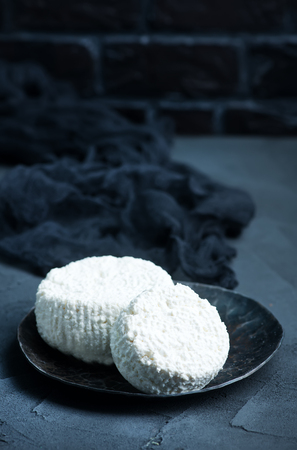 cottage cheese on plate and on a tableの写真素材