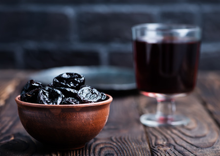 dry plums and drink in the glassの写真素材