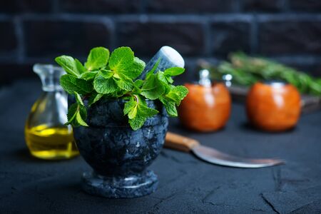 fresh mint in bowl, aroma herb on kitchen tableの写真素材