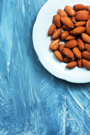 almond on a table, dry almond, nuts on wooden backgroundの写真素材