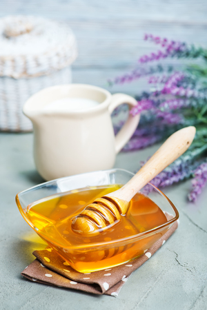 honey in glass bank on a tableの写真素材