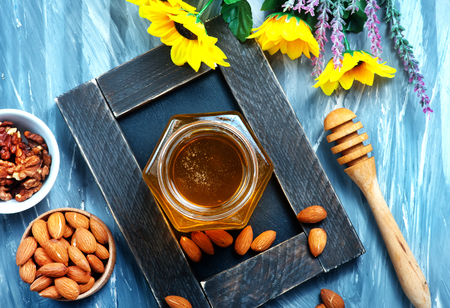 honey in glass bank on a tableの写真素材