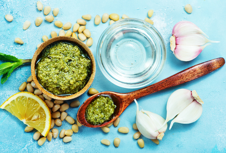 fresh pesto in bowl and on a tableの写真素材