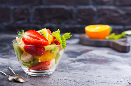 fruit salad in glass bowl on a tableの写真素材