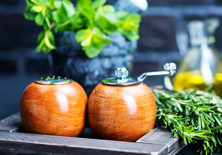 fresh greens with spice in wooden millの写真素材