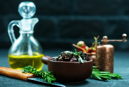 dry olives with salt and oil on a tableの写真素材
