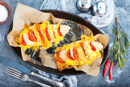 chicken breast with cheese and tomatoの写真素材