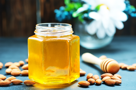 honey with nuts on a table, stock photoの写真素材