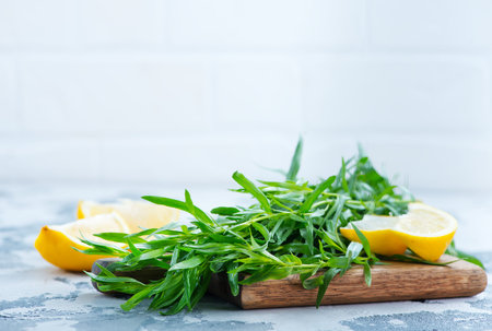 fresh estragon on wooden board and on a tableの写真素材