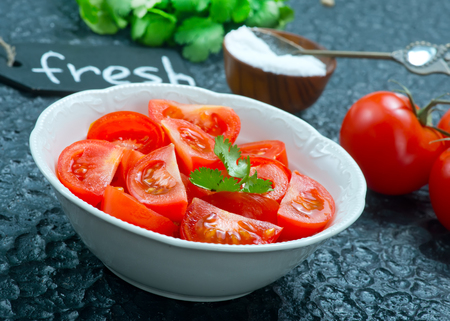 tomato salad on plate and on a tableの写真素材