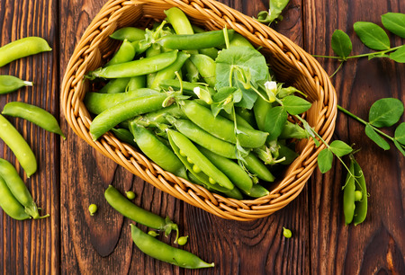 green peas in basket and on a tableの写真素材