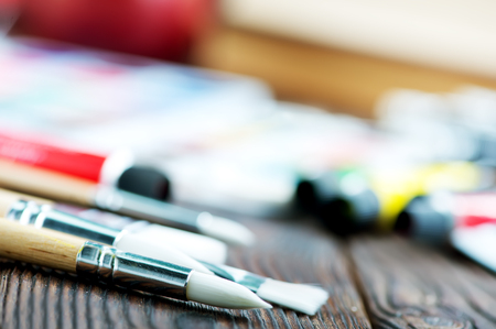 color paint and brushes on a tableの写真素材